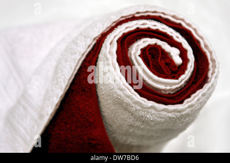 warm, dry, rolled up red and white towels in a spa Stock Photo