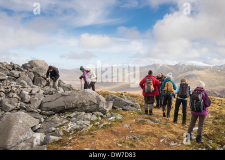 Group of Ramblers taking a break on Carnedd y Filiast part of Marchlyn horseshoe in Snowdonia National Park North Wales UK Stock Photo