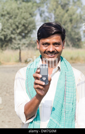1 indian farmer standing with mobile Stock Photo
