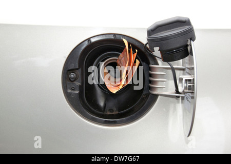 Concept banknotes feeding into petrol refill pipe indicating rise in petrol price Stock Photo
