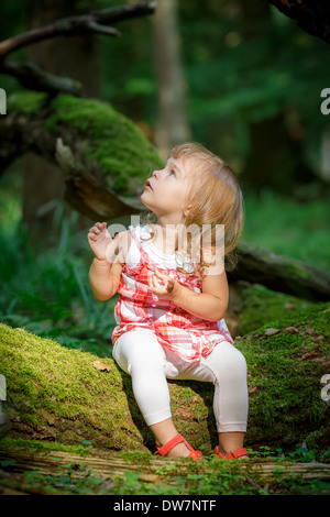 Little girl in the forest Stock Photo