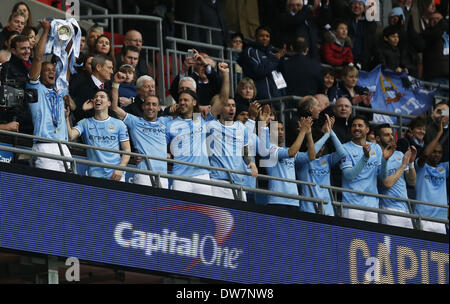 (140303) -- LONDON, March 3, 2014 (Xinhua) -- Vincent Kompany of Manchester City lifts the trophy with teammates after the Capital One Cup(The League Cup) Final between Manchester City and Sunderland at Wembley Stadium in London, Britain on March 2, 2014. Manchester City won 3-1. (Xinhua/Wang Lili)    FOR EDITORIAL USE ONLY. NOT FOR SALE FOR MARKETING OR ADVERTISING CAMPAIGNS. NO USE WITH UNAUTHORIZED AUDIO, VIDEO, DATA, FIXTURE LISTS, CLUBLEAGUE LOGOS OR LIVE SERVICES. ONLINE IN-MATCH USE LIMITED TO 45 IMAGES, NO VIDEO EMULATION. NO USE IN BETTING, GAMES OR SINGLE CLUBLEAGUEPLAYER PUBLICATION Stock Photo