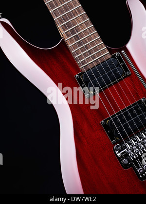 Red electric guitar Ibanez S-series S420 closeup detail on black background Stock Photo