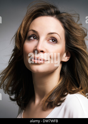 License available at MaximImages.com - Portrait of a beautiful smiling woman with daydreaming expression Stock Photo