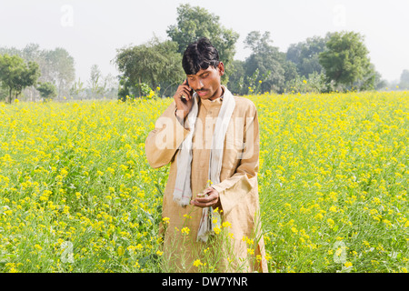 1 Indian farmer standing in farms and talking Stock Photo - Alamy