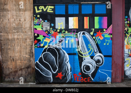 Graffiti on a garage doors with love, peace and music theme