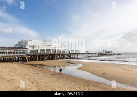 Sandy beach at low tide and Sandown Pier, Sandown, Isle of Wight, UK with blue sky and white clouds Stock Photo