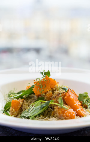salad with pumpkin, seeds and pea on background of light window in city Stock Photo