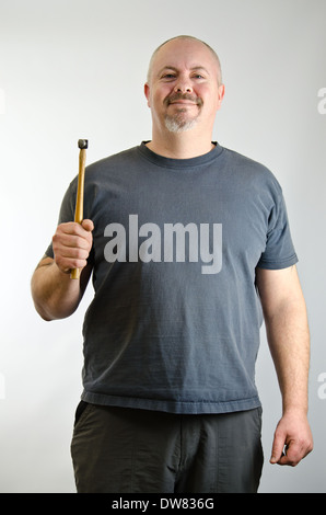 Confident looking man holding a hammer Stock Photo