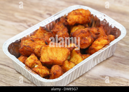Fried cod pieces in take away tray Stock Photo