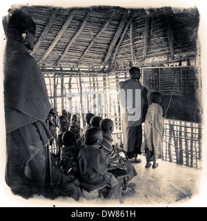 Maasai children at English lecture in the Ngorongoro Conservation Area in the Crater Highlands area of Tanzania Eastern Africa Stock Photo