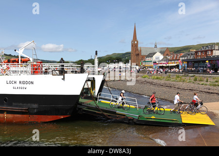 Cyclist leaving a Calmac Ferry after sailing from the Island of Great Cumbrae to Largs, Firth of Clyde, Scotland, UK Stock Photo