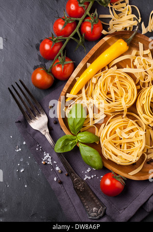 noodles with chili, tomatoes and basil Stock Photo