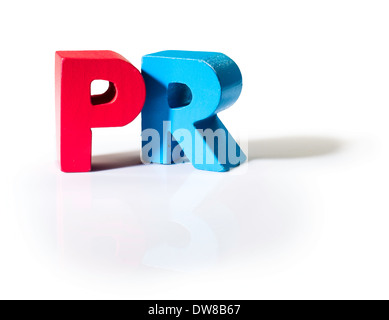 Multicolored text PR made of wood. White background Stock Photo