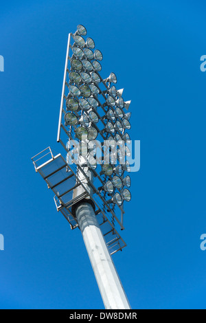 Stadium floodlights against the blue sky. Stock Photo