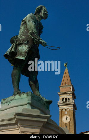 Statue of local composer and violinist Giuseppe Tartini and the clock tower of St. George's Cathedral. Piran. Slovenia Stock Photo