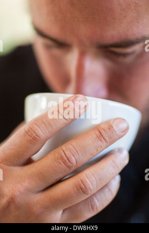 An El Salvadoran coffee producer cups different varieties of his beans at his roasting facility in Juayua El Salvador Stock Photo