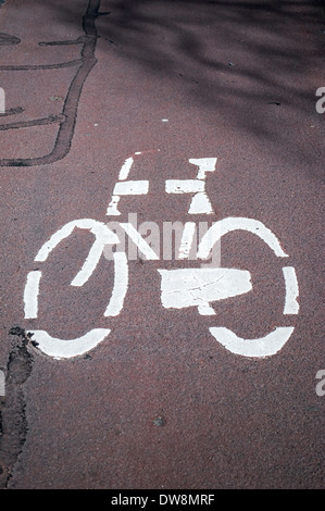 Painted road sign indicating a cycling lane Stock Photo