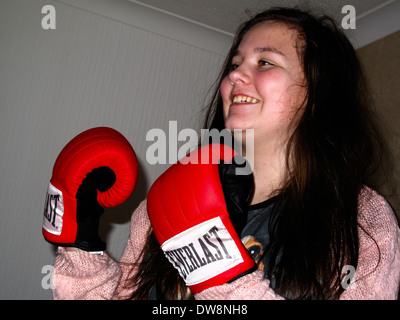 12 year old girl playing with Everlast boxing gloves Stock Photo