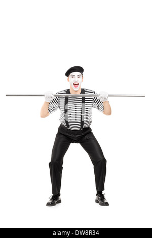 Full length portrait of mime artist holding a big metal pipe Stock Photo