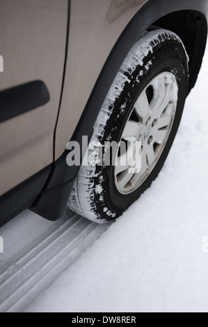 Front right wheel tire tyre in the snow on a Honda CRV small SUV all wheel drive Stock Photo