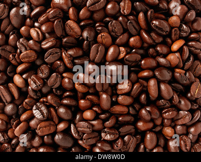 Coffee beans background with roasted natural seeds for brewing espresso or cappuccino as a natural food concept with a java blend of different types of roasts from around the world. Stock Photo