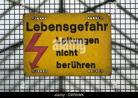 Warning sign for high voltage lines Stock Photo