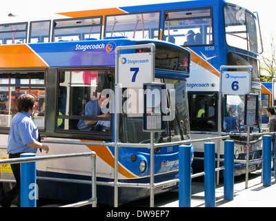 Bus drivers talking Chichester bus station Chichester West Sussex UK Stock Photo