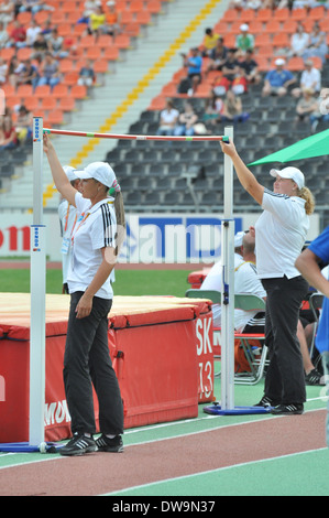 Volunteers raise the bar in high jumping during the 2013 IAAF World Junior Championships on July 12-14, 2013 Stock Photo