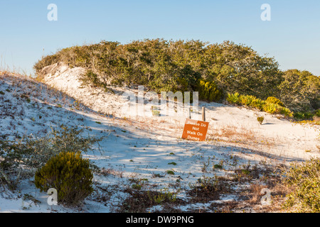 Sign requests that visitors please stay off dunes in the Bon Secour Wildlife Refuge at Gulf Shores, Alabama Stock Photo