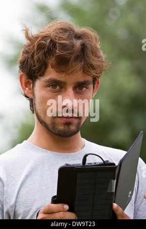 Afghan student using a solar powered tablet Stock Photo