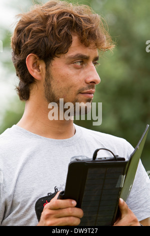 Afghan student using a solar powered tablet Stock Photo