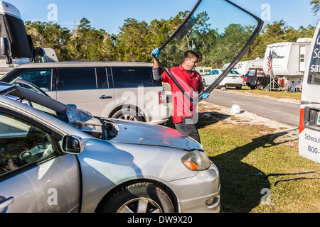 Mobile service technician replacing windshield glass on Toyota Corolla Stock Photo