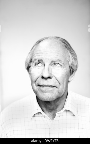 Black and white studio portrait of senior man looking up Stock Photo