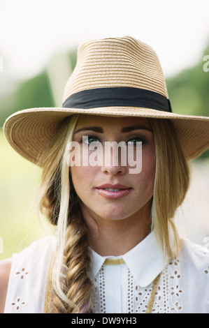 Portrait of young woman wearing hat