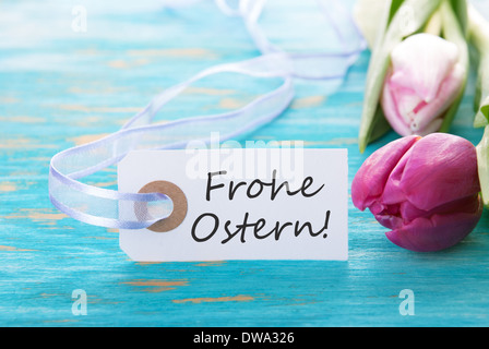 Banner with the german words Frohe Ostern which means Happy Easter on turquiose background Stock Photo