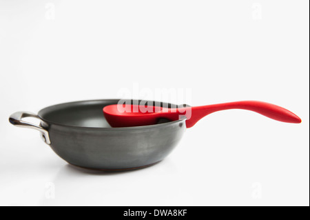Pot and red spoon kitchenware Stock Photo