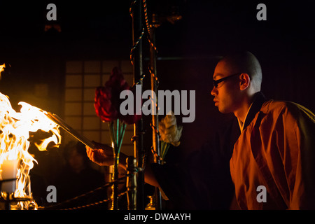 Buddhist priests attend the fire ceremony in one of the temples in ...