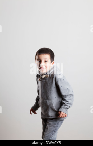 Smiling boy, age 6,ti toe Stock Photo