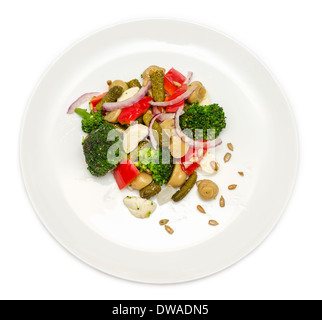 Broccoli salad with bell peppers, pickled cucumber, mushrooms and mozzarella. Isolated on white background. Stock Photo
