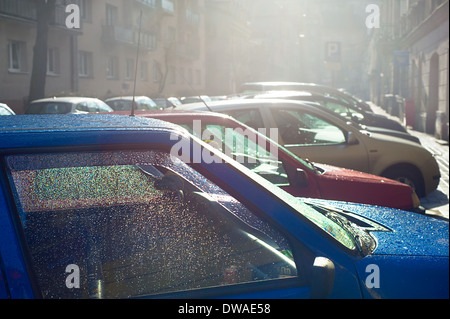 Car parking on the Krakow street in the rain. Poland Stock Photo