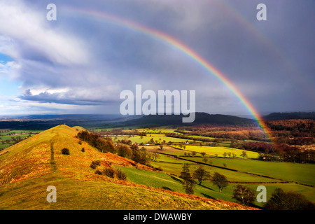 Rainbow after rainstorm over The Lawley hill, Church Stretton, Shropshire, UK Stock Photo
