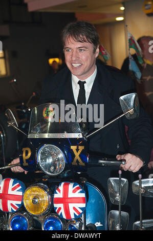 Brynmawr, Baenau Gwent, Wales, UK. 4th March 2014. Jonny Owen tries out one of the classic motor scooters which have been organised for the premiere. Merthyr Tydfil’s very own Jonny Owen premieres his latest film SVENGALI, co-starring Vicky McClure, which was shot on location in the Welsh mining valleys. The premiere is held at the oldest independent cinema in Wales – The Market Hall Cinema in Brynmawr. Credit:  Graham M. Lawrence/Alamy Live News. Stock Photo