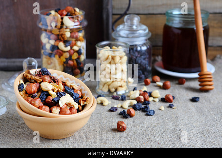 mix nuts in a bowl on the table and jar, food closeup Stock Photo
