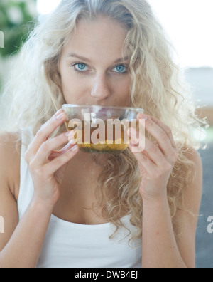 Portrait of young woman drinking herbal tea Stock Photo