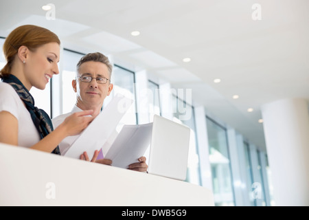 Business people discussing over documents in office Stock Photo