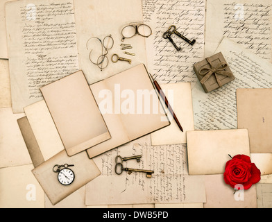 nostalgic sentimental background. old love letters, vintage accessories, diary and red rose flower Stock Photo