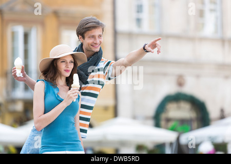Young couple enjoying ice cream cones during vacation Stock Photo