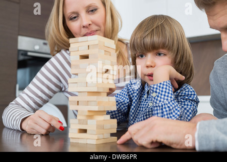 Family playing with wooden blocks at home