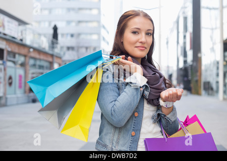 Portrait of woman carrying shopping bags Stock Photo